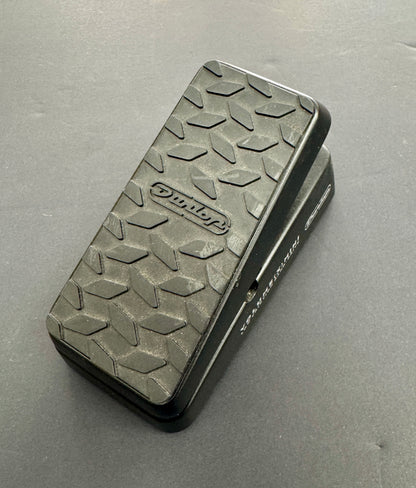 Black guitar effects pedal with textured surface on a gray background