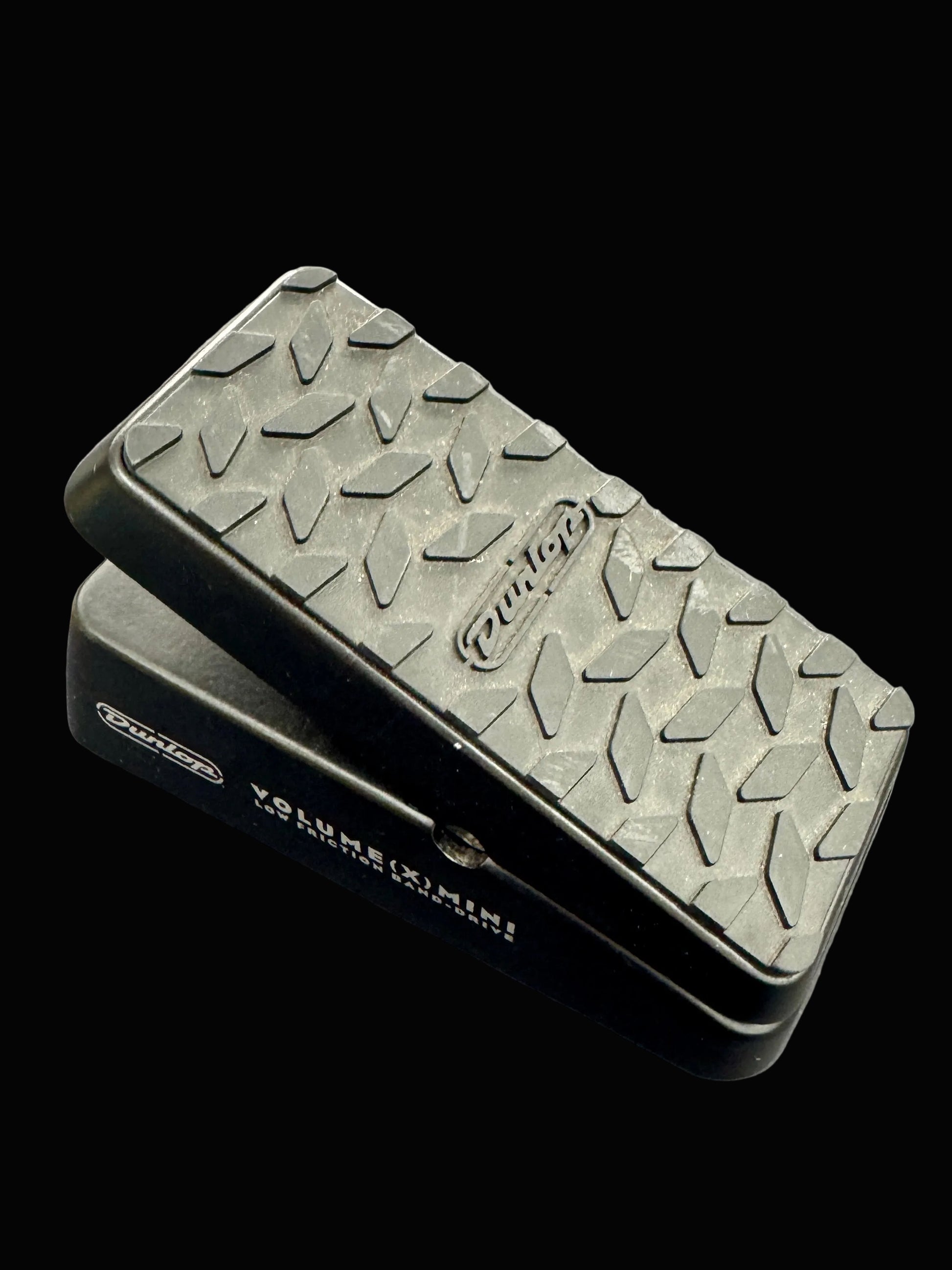 Volume pedal with textured surface on a gray background