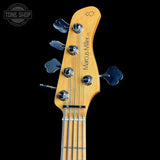 Guitar headstock with 'Marcus Miller' branding on a black background