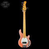 Electric bass guitar with a rosewood fingerboard on a black background, featuring the Tone Shop logo.