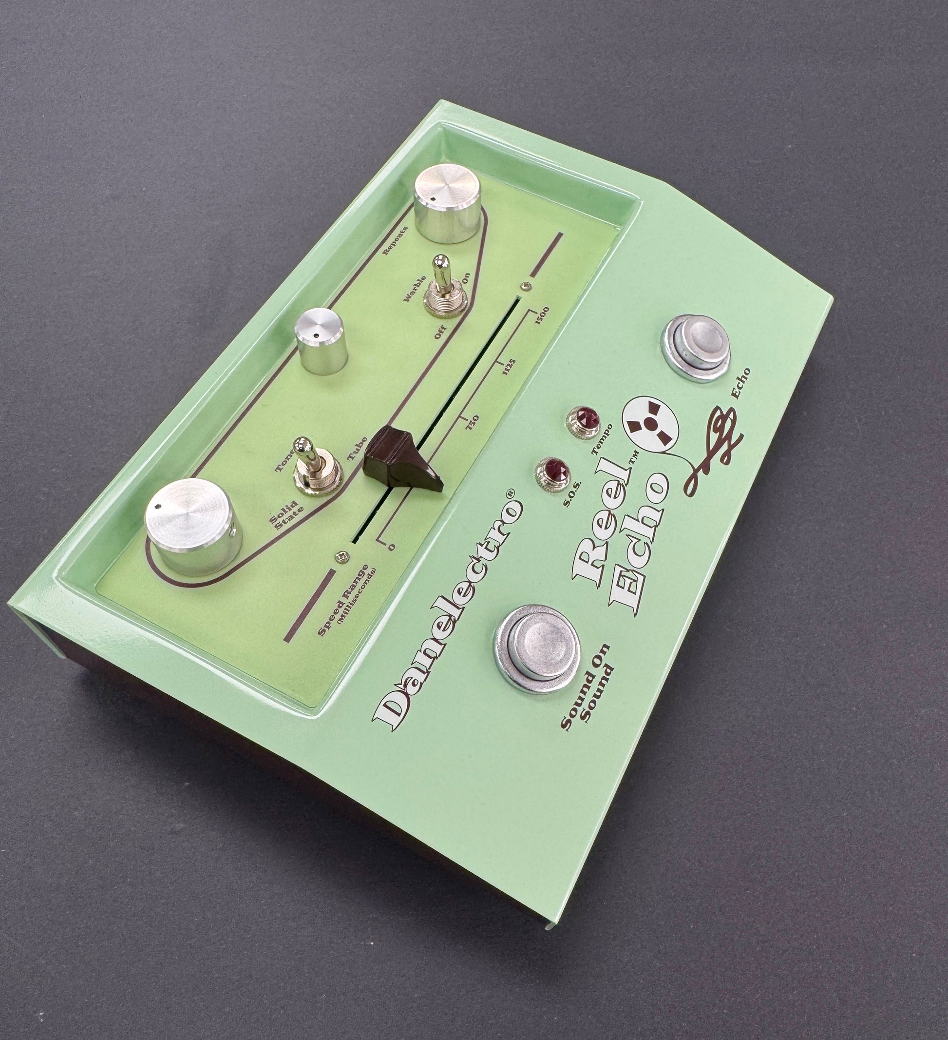 Green guitar effects pedal with 'Danelectro' branding on a dark background