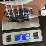 Bass guitar on a digital scale displaying weight