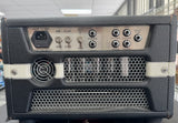 Vintage-style guitar amplifier with control knobs and speaker grille.