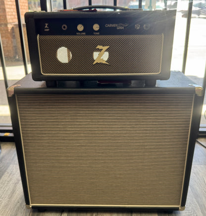 Guitar amplifier with 'Carmen USA' branding on a wooden surface.
