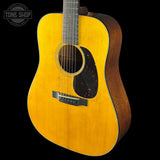 Acoustic guitar with a visible brand logo on a black background