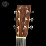 Guitar headstock with Martin & Co logo on a black background