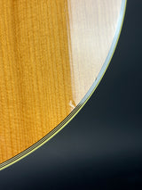 Close-up of a light wood grain surface with a curved edge and dark background.