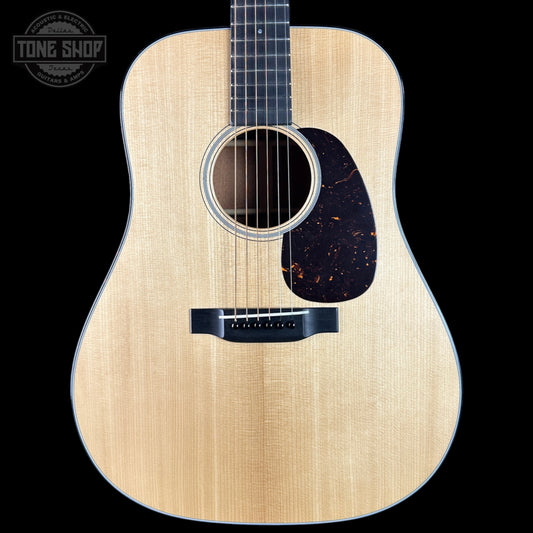 Acoustic guitar with a visible brand logo on a black background