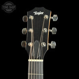 Taylor 112ce Studio Prototype headstock closeup over a black background. 