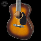 Acoustic guitar with a sunburst finish on a black background, featuring the Tone Shop logo.
