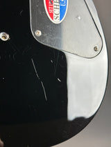 Wear on back of Used Schecter Omen-8 Left Handed Black.