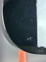 Wear on back of Used Schecter Omen-8 Left Handed Black.