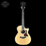 Taylor 314ce Prototype Next Generation  Acoustic guitar with a tortoiseshell pickguard on a black background, featuring the Tone Shop logo.
