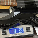 Used Schecter Omen-8 Left Handed Black on scale displaying weight.