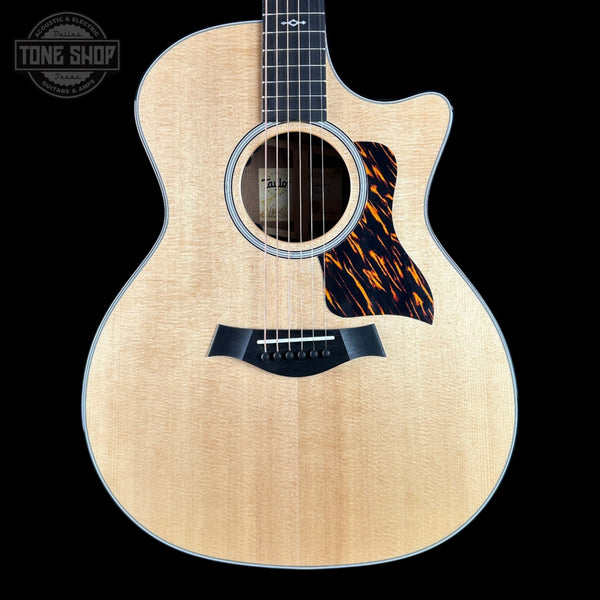 Taylor 314ce Prototype Next Generation  Acoustic guitar with flame maple top on a black background, featuring 'Tone Shop' logo.