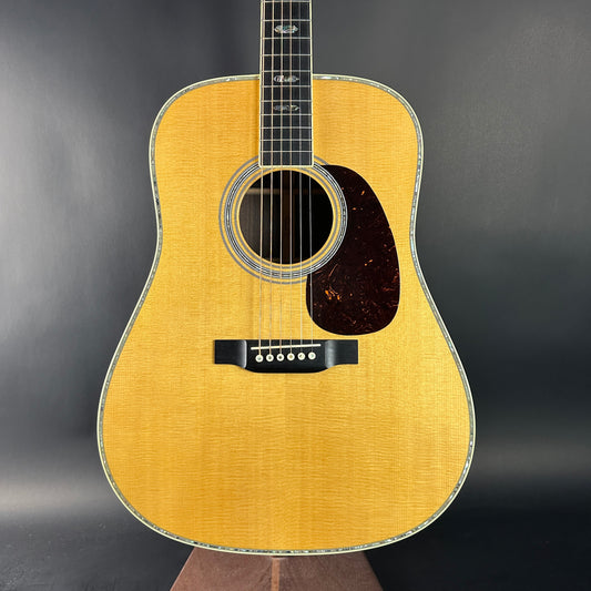 Acoustic guitar with a wooden finish on a dark background