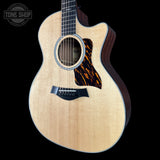 Taylor 314ce Prototype Next Generation  Acoustic guitar with a tortoiseshell pickguard on a black background, featuring the Tone Shop logo.