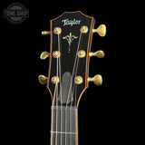 Taylor Builder's Edition 914ce Prototype Next Generation guitar headstock with gold tuning pegs on a black background