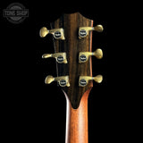 Close-up of Taylor Builder's Edition 914ce Prototype Next Generation's headstock with tuning pegs on a black background, featuring the Taylor brand.