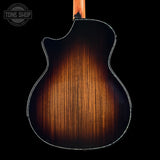 Taylor Builder's Edition 914ce Prototype Next Generation Back view of a wooden acoustic guitar with a dark finish on a black background, featuring the Tone Shop logo.