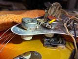 Close-up of a guitar's electronic components with a blurred background