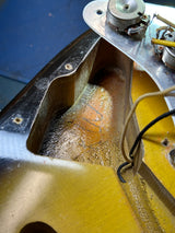 Close-up of a mechanical component with wires and a blue background