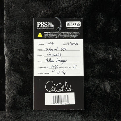 PRS Guitars label on a textured black background