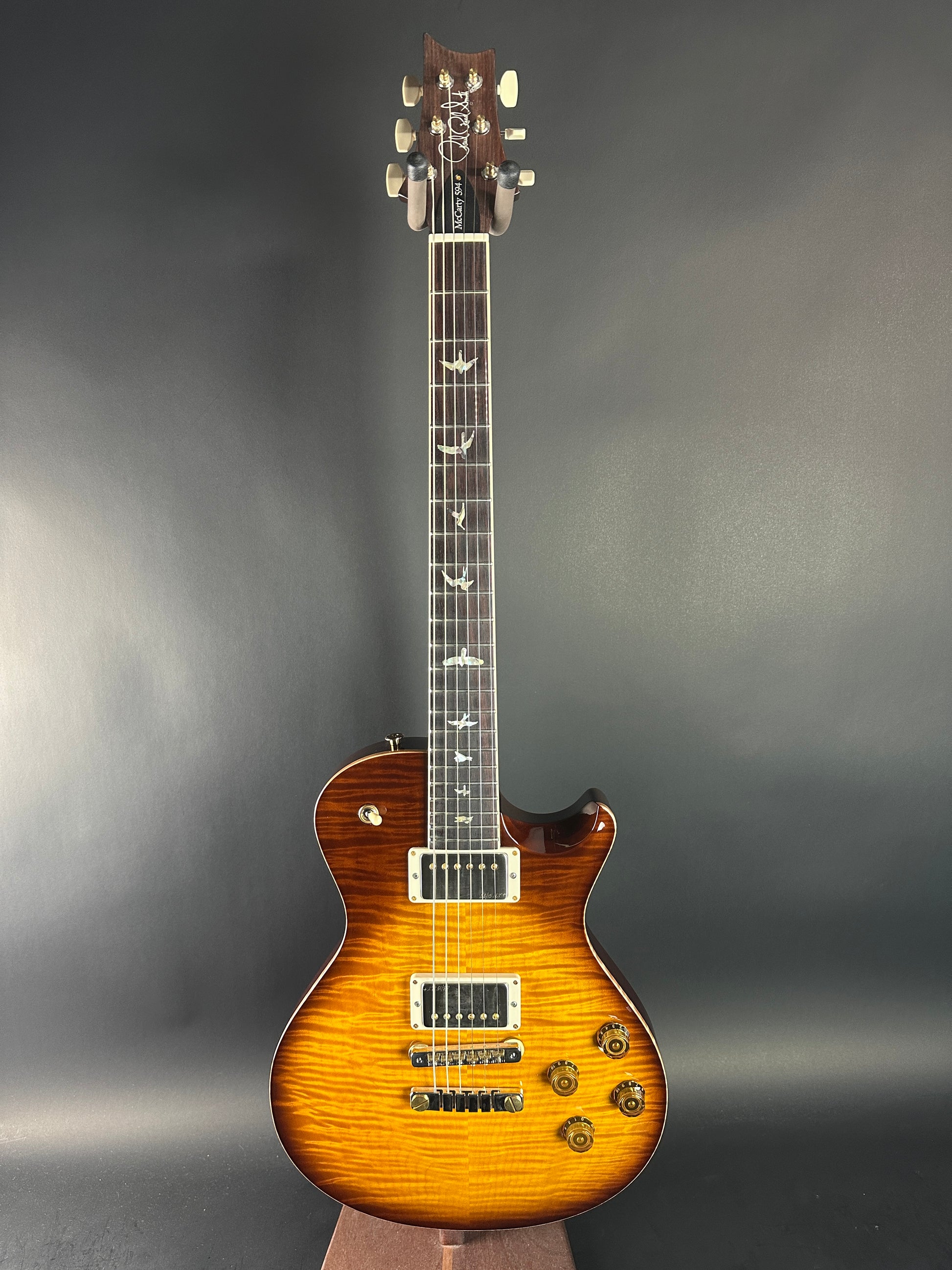 Electric guitar with a sunburst finish on a gray background
