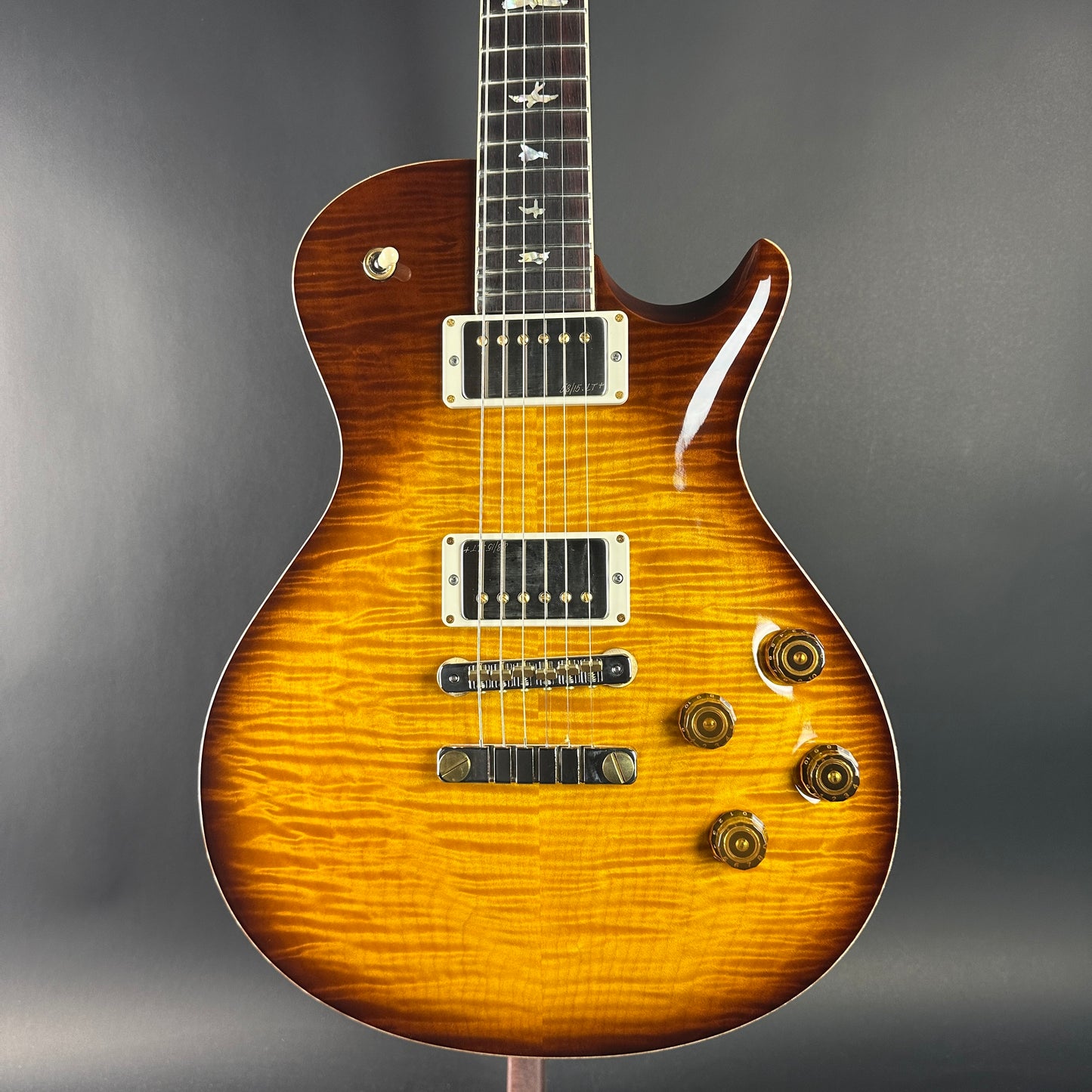 Electric guitar with a sunburst finish on a gray background