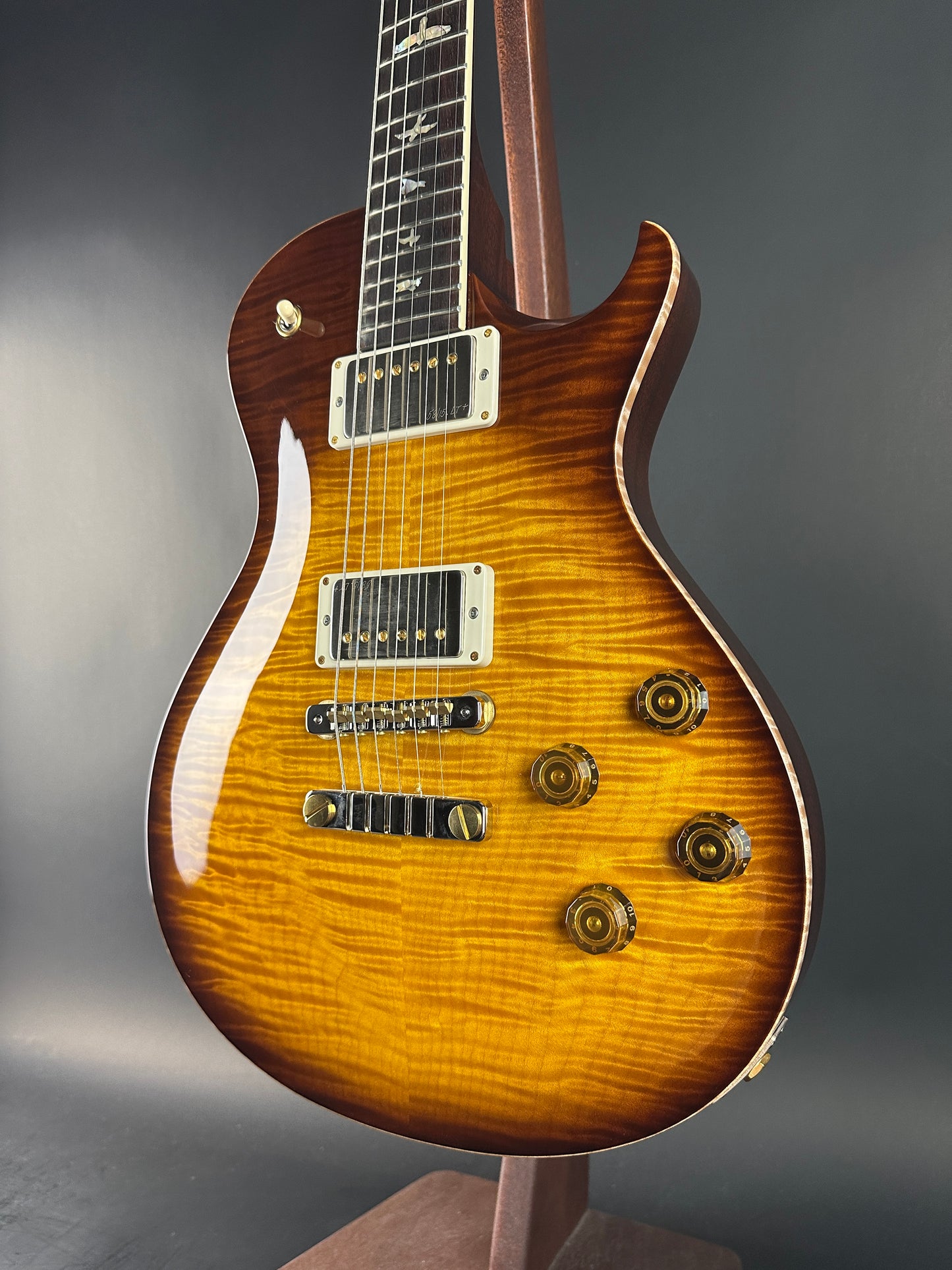 Electric guitar with a sunburst finish on a gray background