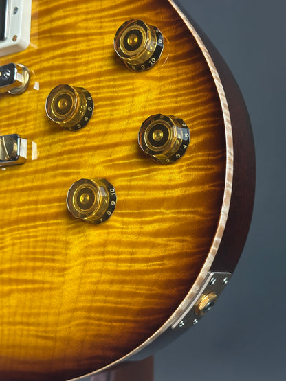 Close-up of a guitar's control knobs with a wooden finish.