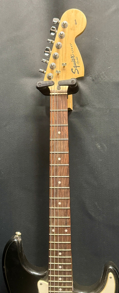 Electric guitar with a black finish on a dark background