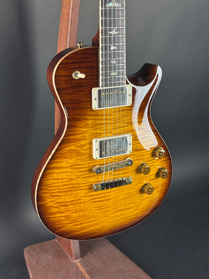 Electric guitar with a sunburst finish on a dark background