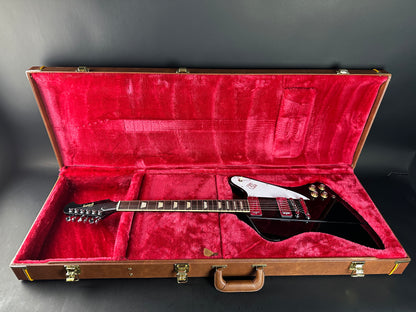 Electric guitar in a red-lined case on a gray background