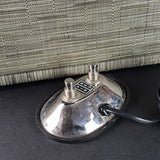 Metal footswitch with 'Vyre' branding on a textured surface