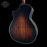 Close-up of Taylor Builder's Edition 514ce Prototype's back with a dark wood finish on a black background, featuring the Tone Shop logo.