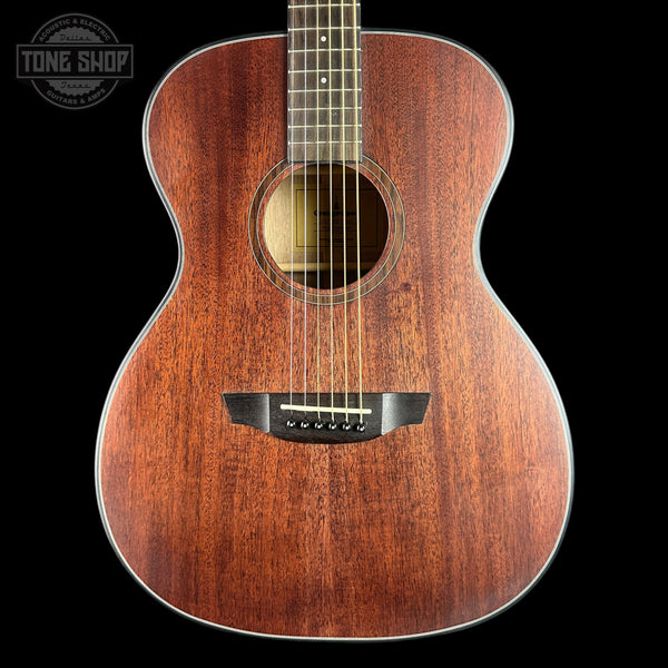 A close-up studio shot of an acoustic guitar's wooden body against a solid black background, with a Tone Shop watermark in the top-left corner.