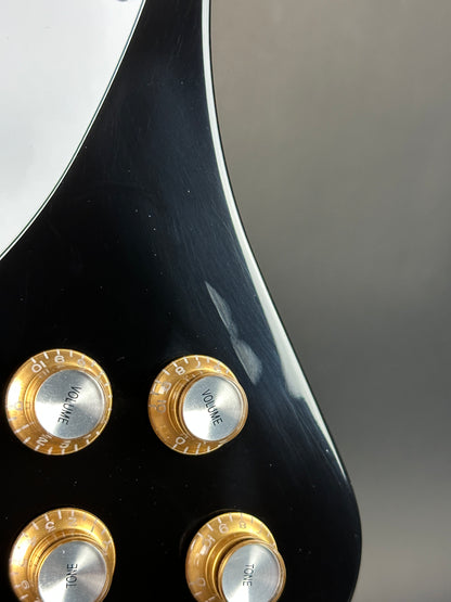 Close-up of a guitar's control knobs with a blurred background