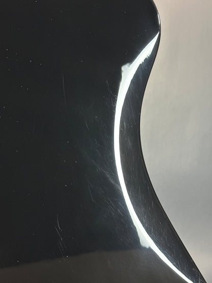 Close-up of a curved metallic surface with reflections