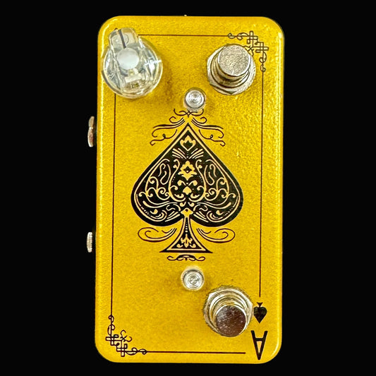 Yellow guitar effects pedal with a spade symbol on a black background