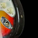Close-up of a guitar's control panel with two tone knobs on a black background