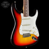 Fender Stratocaster guitar with a sunburst finish on a black background