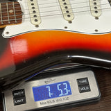 Guitar on a digital scale displaying weight