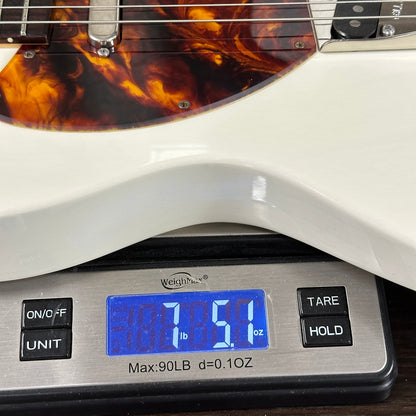 Guitar on a digital scale displaying weight
