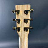 Guitar headstock with tuning pegs on a dark gray background