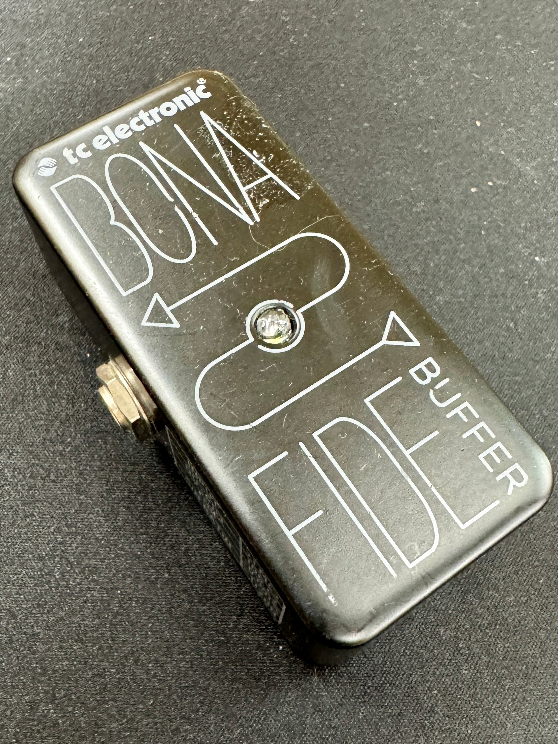 Small electronic device labeled 'Bona Fide Buffer' on a dark surface