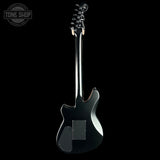 Black electric guitar on a white background with 'Tone Shop' logo.