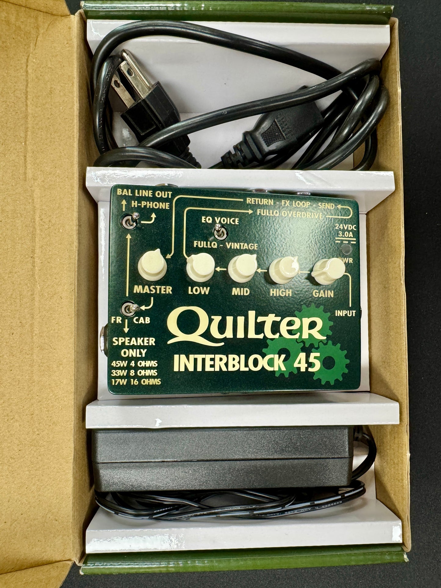 Quilter Interblock 45 audio pedal with cables inside a cardboard box