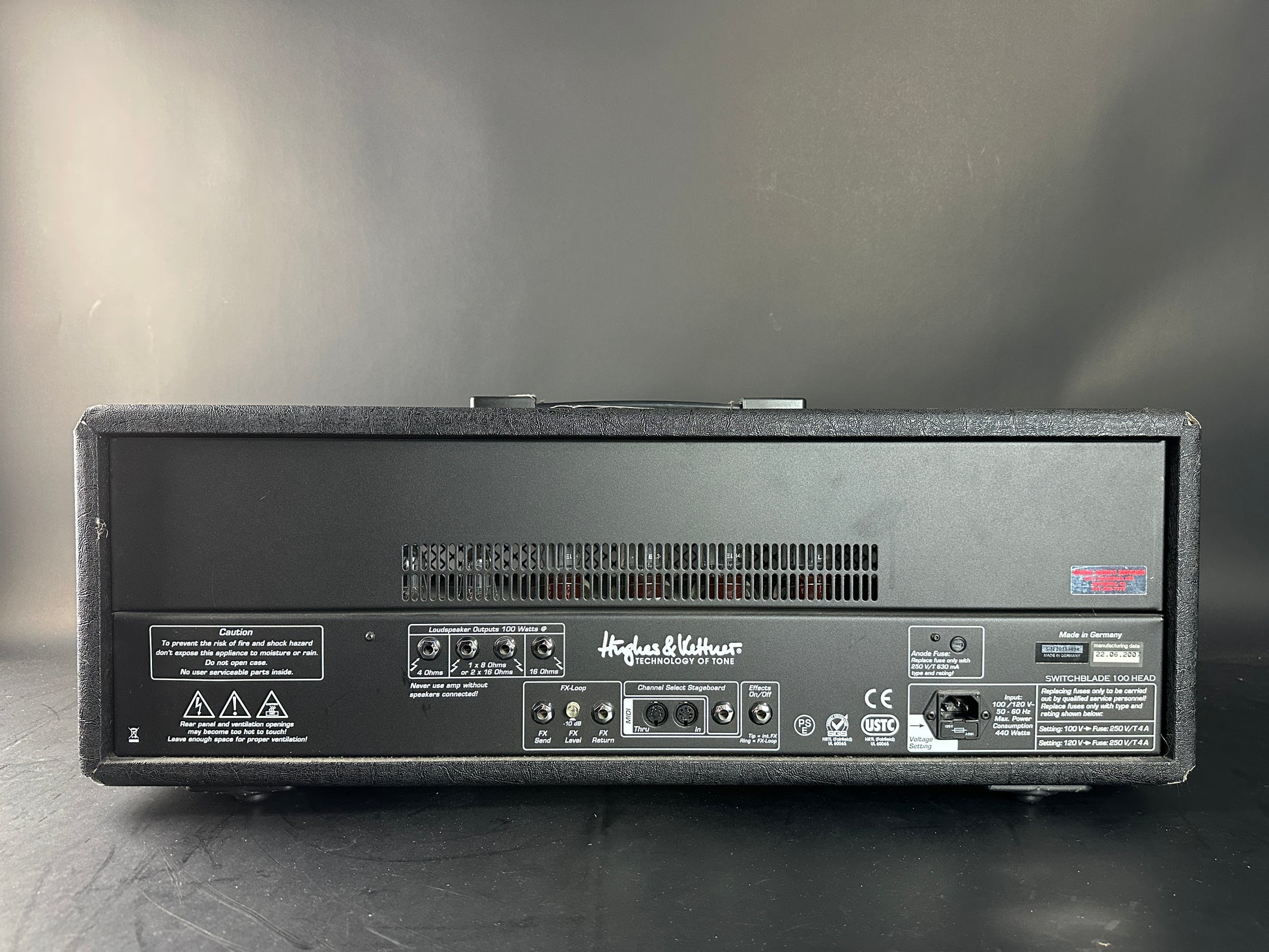 Back panel of a Hughes & Kettner guitar amplifier on a gray background