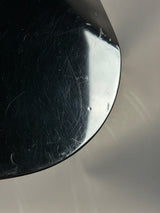 Close-up of a black circular object with reflective surface